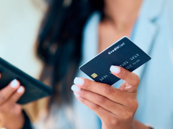 Someone using a banking app and a payment card