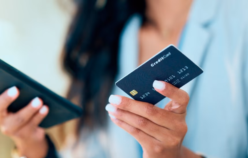 Someone using a banking app and a payment card